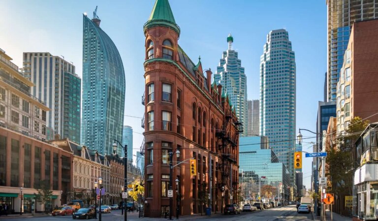 Streetscape with Toronto's iconic Flatiron Building and skyscrapers in the background