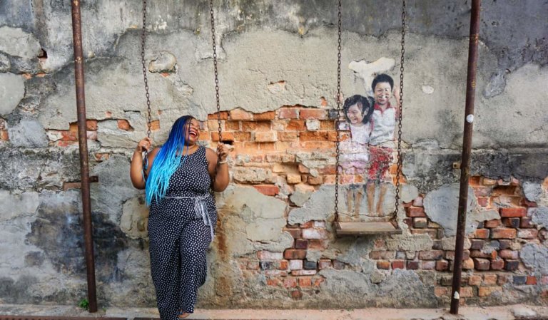 Annette posing near a mural in Penang