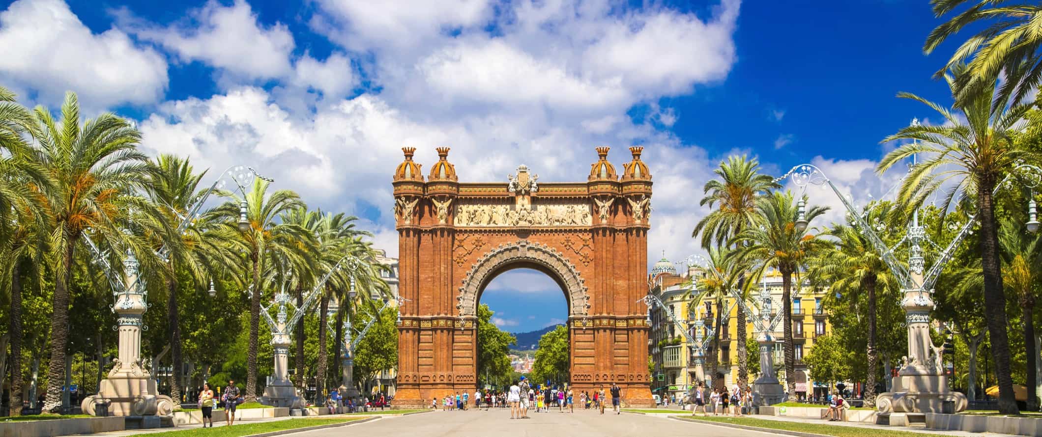 A waide open pedestrian street with an arch in Barcelona, Spain