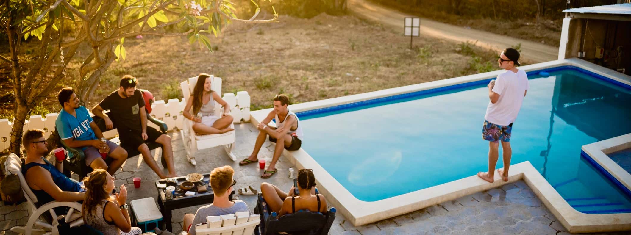 Friends at a hostel relaxing by the pool