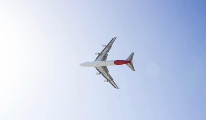 A lone aircraft flying through the blue sky