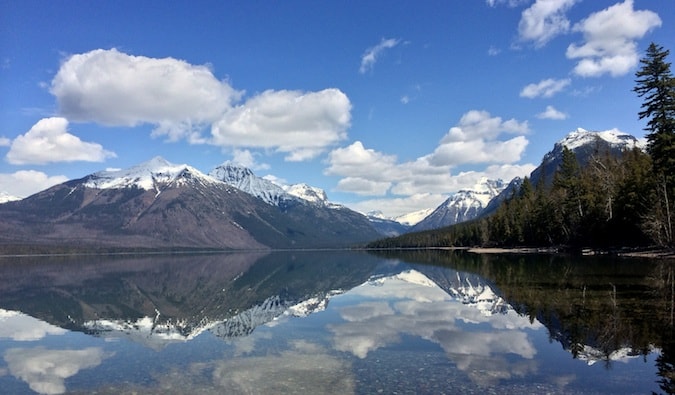 Calm waters and snow-capped mountains in Glacier National Park