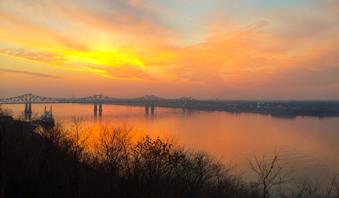 A bright orange sunset over the water near Natchez, Mississippi