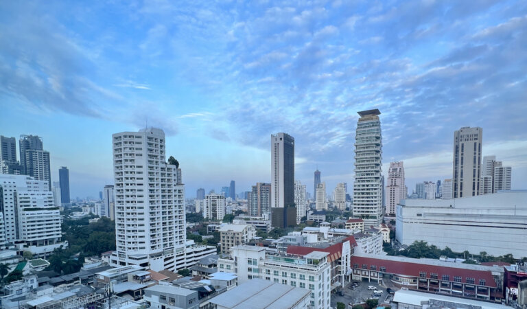 The towering skyline of downtown Bangkok, Thailand with a bright blue sky