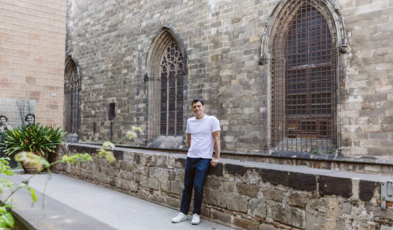 Nomadic Matt posing for a photo on a quiet street in Barcelona, Spain