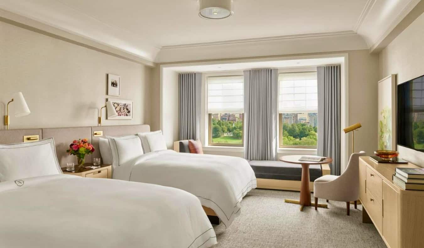 Two large beds in a bright and spacious hotel room at the Newbury Hotel in Boston, USA