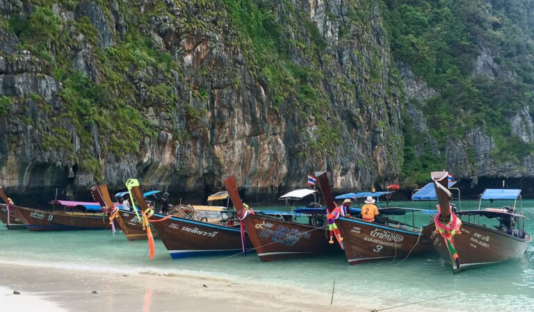 Boats parked on the famous beach of beautiful Ko Phi Phi in Thailand