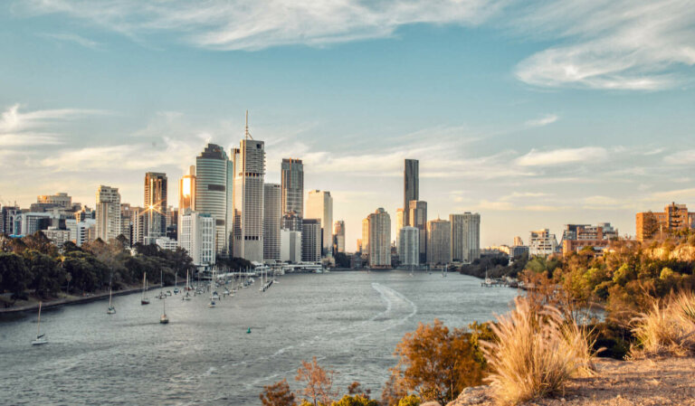 The towering downtown skyline of Brisbane as seen from over the river on a sunny day in Australia