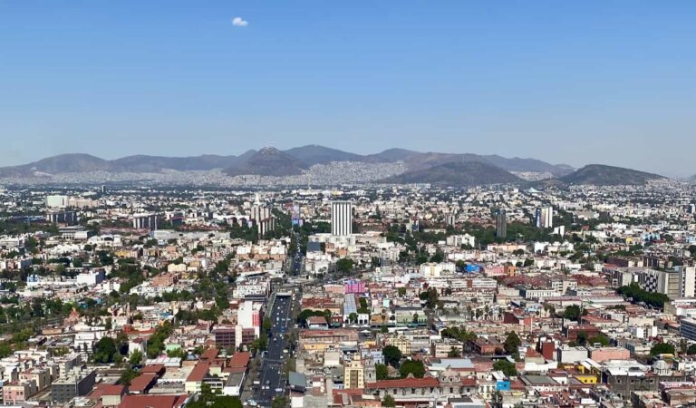 The sunny view overlooking Mexico City, Mexico with mountains in the distance