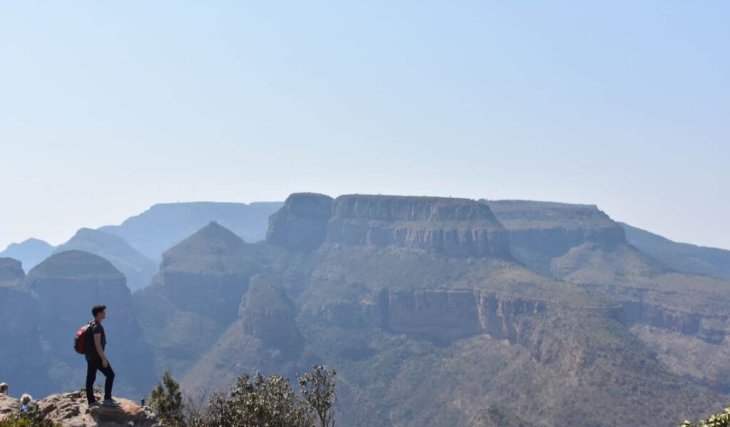 Nomadic Matt standing on a mountain looking out over the sprawling African landscape