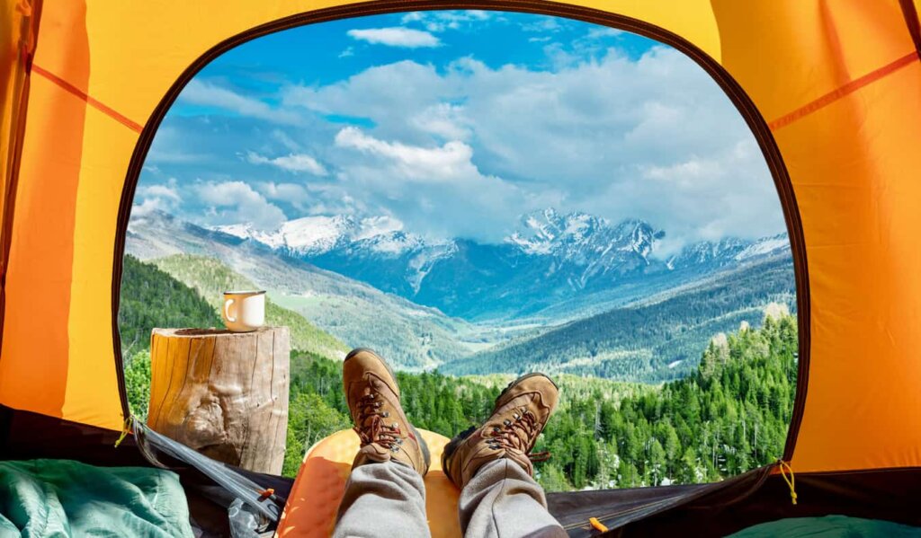 a traveler lounging in a small tent while traveling abroad in Europe