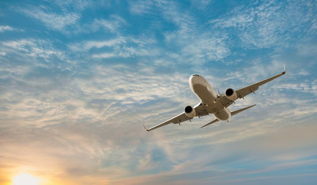 a plane soaring through a cloudy sky