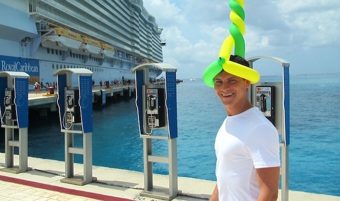 Nomadic Matt on a cruise in the caribbean with a funny balloon hat