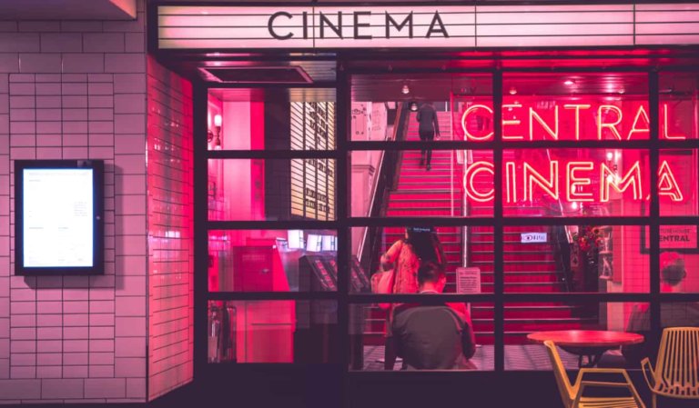 The neon lights of an old cinema at night