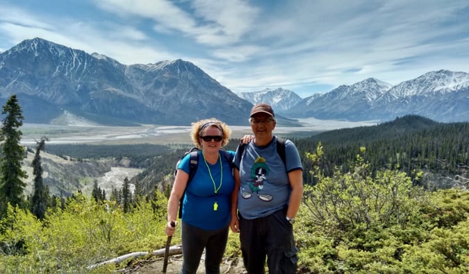 Boomer couple Esther and her husband pose for a photo abroad