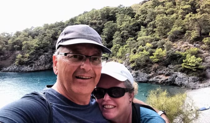 Esther and her husband posing for a photo while hiking