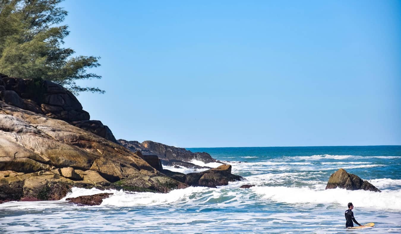 a man surfing on the beach in Florianopolis, Brazil