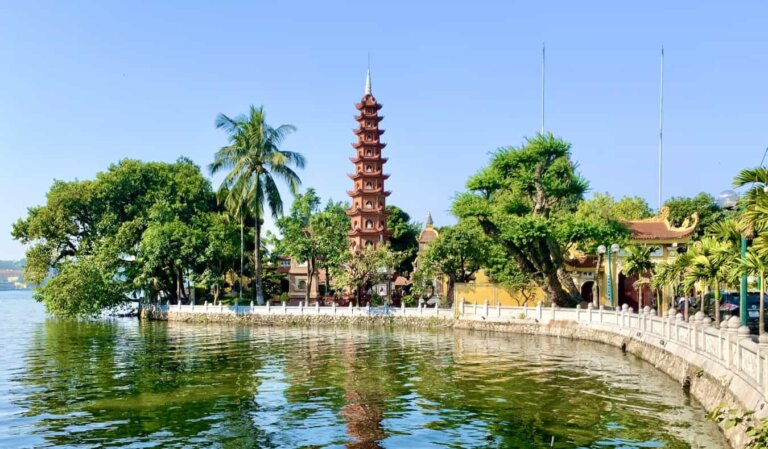 A sunny day near the lake in Hanoi, with a tall, historic pagoda in the background