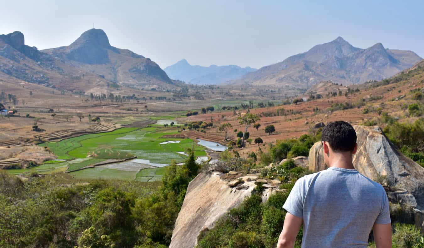 Nomadic Matt posing for a photo while looking out over a massive valley in Africa