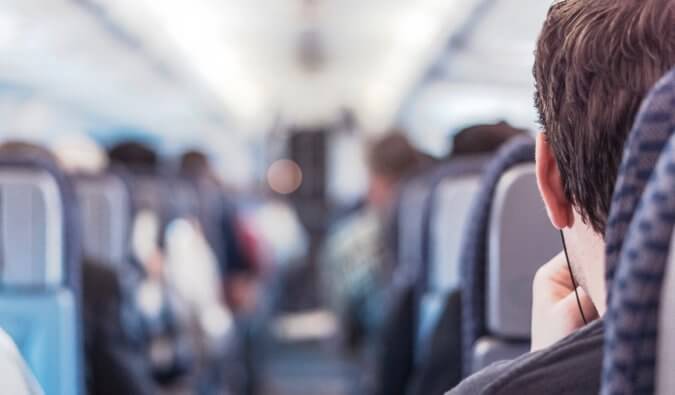 a close-up photo of a man sitting in an airplane