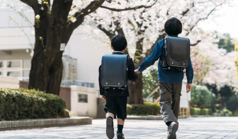 Two young Japanese students walking to school