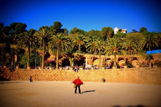 Jessica, a female traveler, posing for a photo in a large clearing surrounded by people