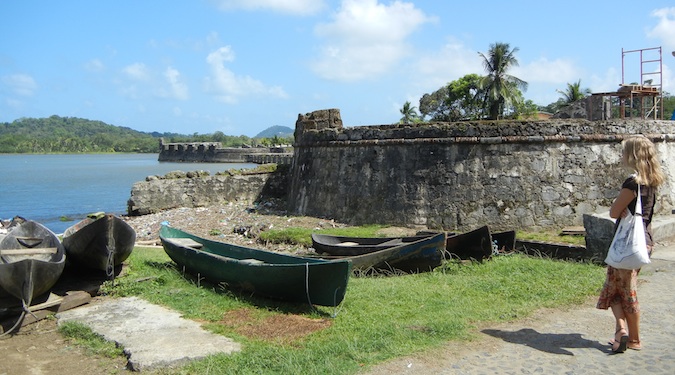 girl by fortress with canoes