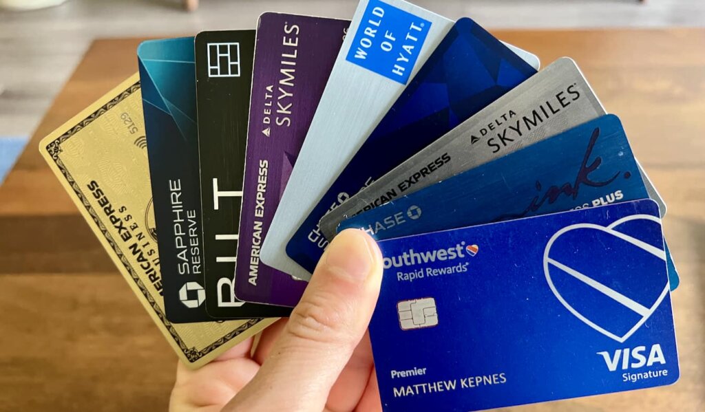 Nomadic Matt holding the best travel credit cards