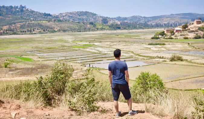 Nomadic Matt standing on a small hill in Africa