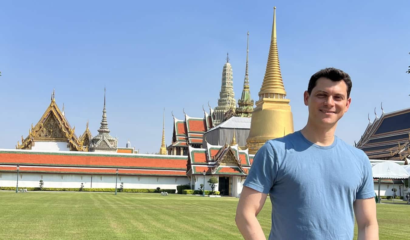 Nomadic Matt standing in front of a temple in Thailand, a popular place to teach English