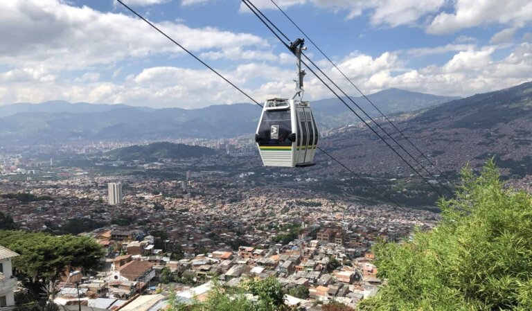 The skyline of Medellin, Colombia, with a cable car running through the foreground and mountains in the background