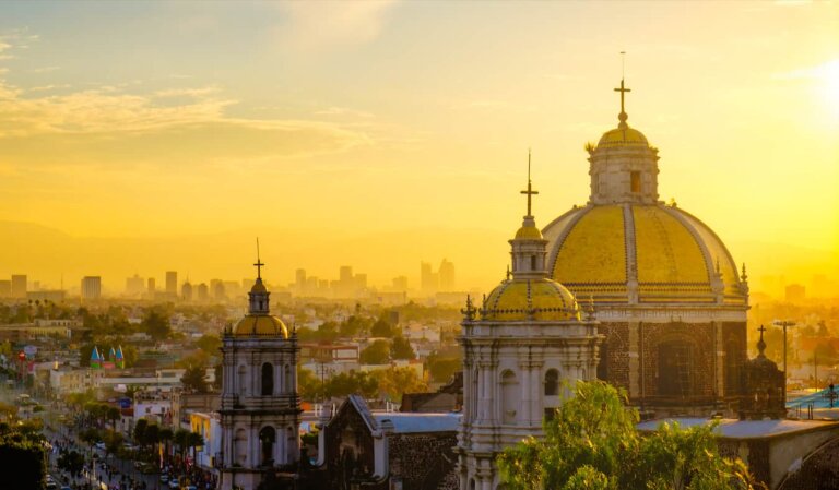 A golden sky over the sprawling Mexico City skyline in Mexico