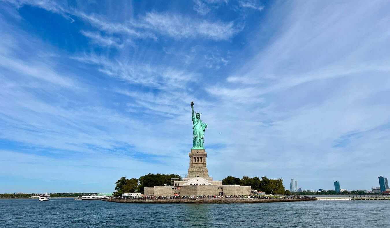 Nomadic Matt taking a photo of the Statue of Liberty in NYC, USA