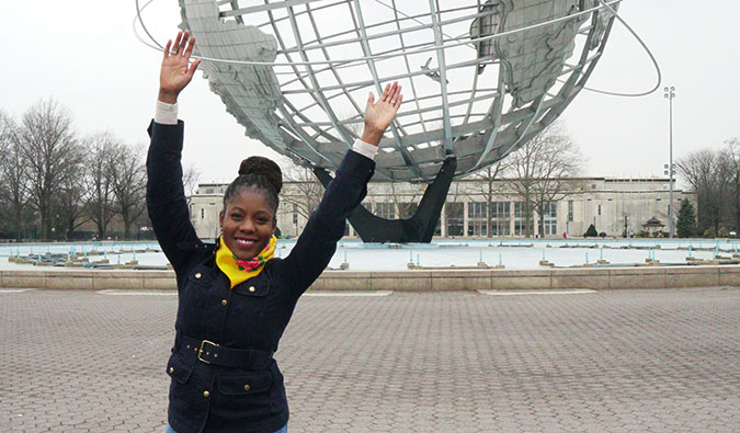 oneika posing in front of a globe