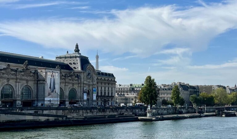 A sunny day overlooking the river Seine in Paris, France with historic buildings in the distance