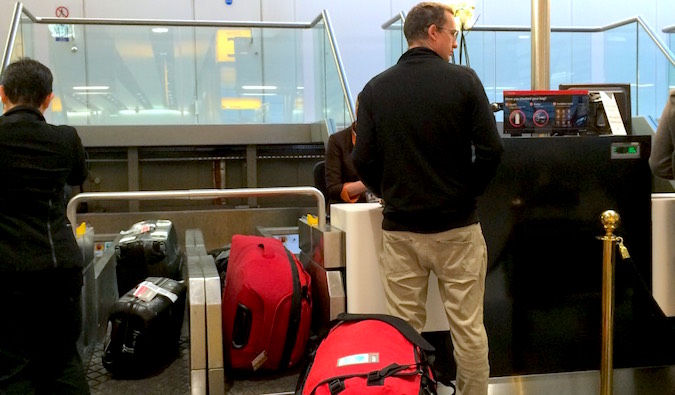 Keith checking in the gear after two months of travelling - Etihad Business Class from London to Sydney