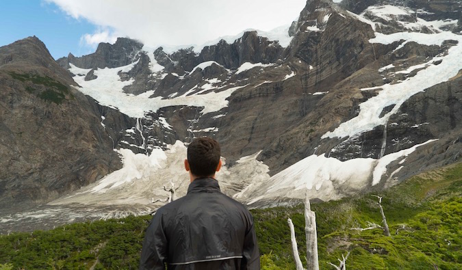 Nomadic Matt looking at mountains in Patagonia