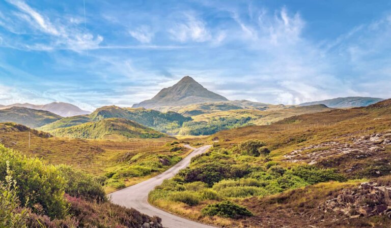 A beautiful blue sky over the rugged highlands of Scotland on a road trip