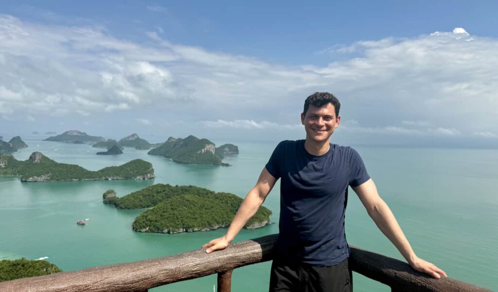 Nomadic Matt posing for a photo overlooking the beautiful islands of sunny Thailand