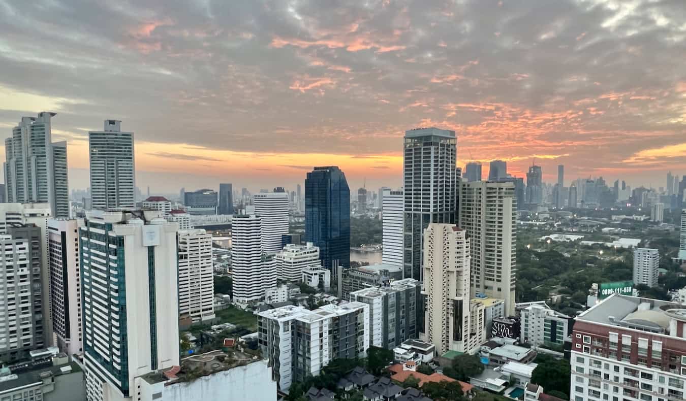 The towering skyline of chaotic Bangkok, Thailand at sunset