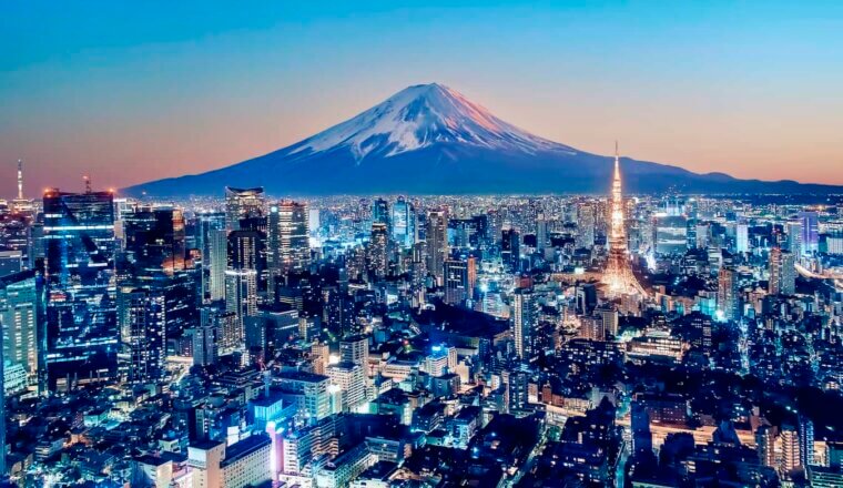 A view overlooking Tokyo at night with Mount Fuji in the background