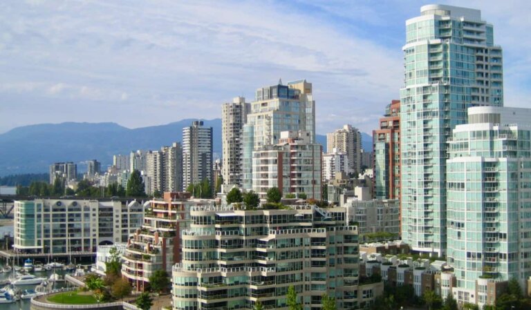 The towering skyline of Vancouver, Canada with mountains in the distance