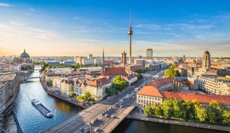 The sweeping skyline of Berlin as seen from above the water, featuring the Berlin Cathedral in the distance