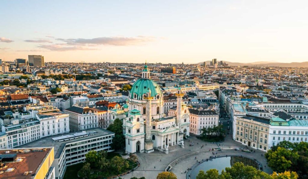 A stunning drone view of Vienna, Austria with the Karlskirche in the foreground